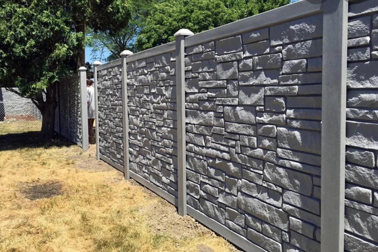 Gray SimTek stone-look privacy fence with matching posts at a Utah property