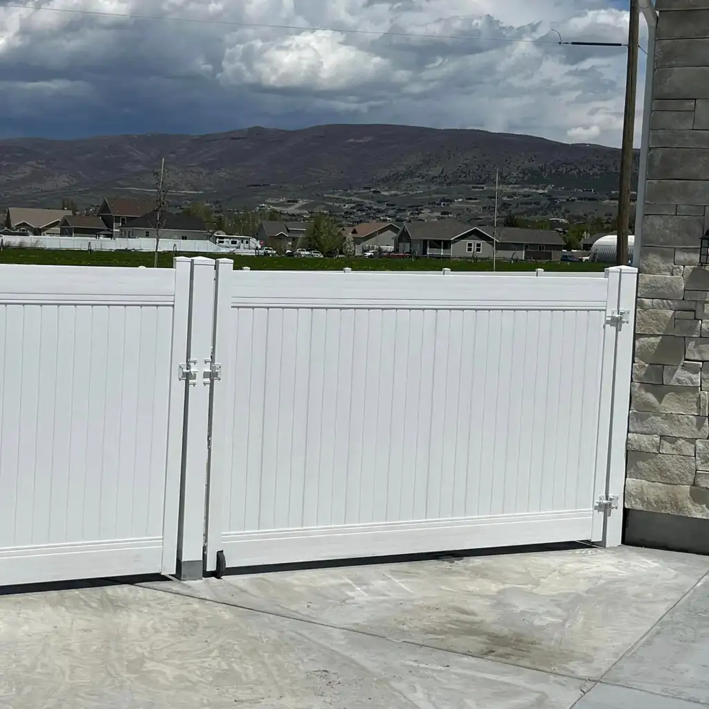 Modern white and black privacy fence installed beside a Utah home