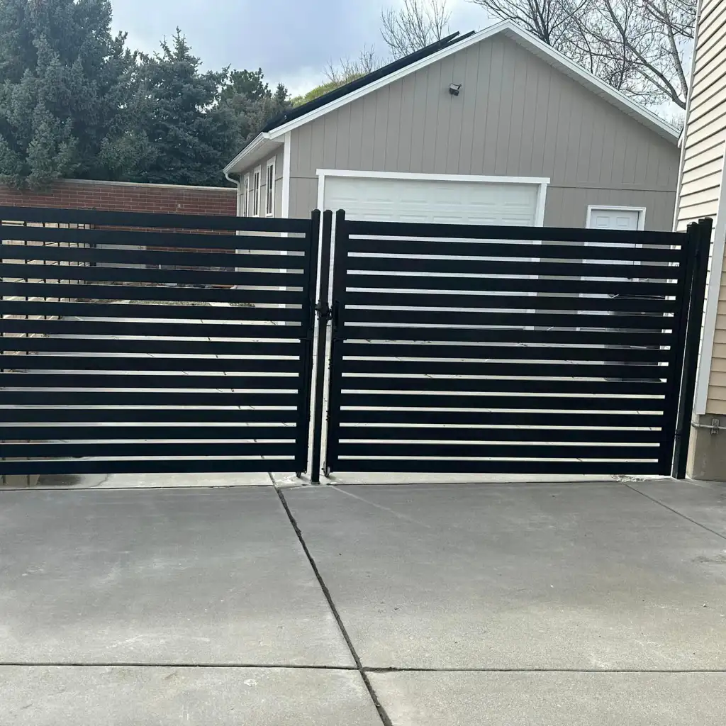 Black horizontal metal driveway gate installed at a Utah home