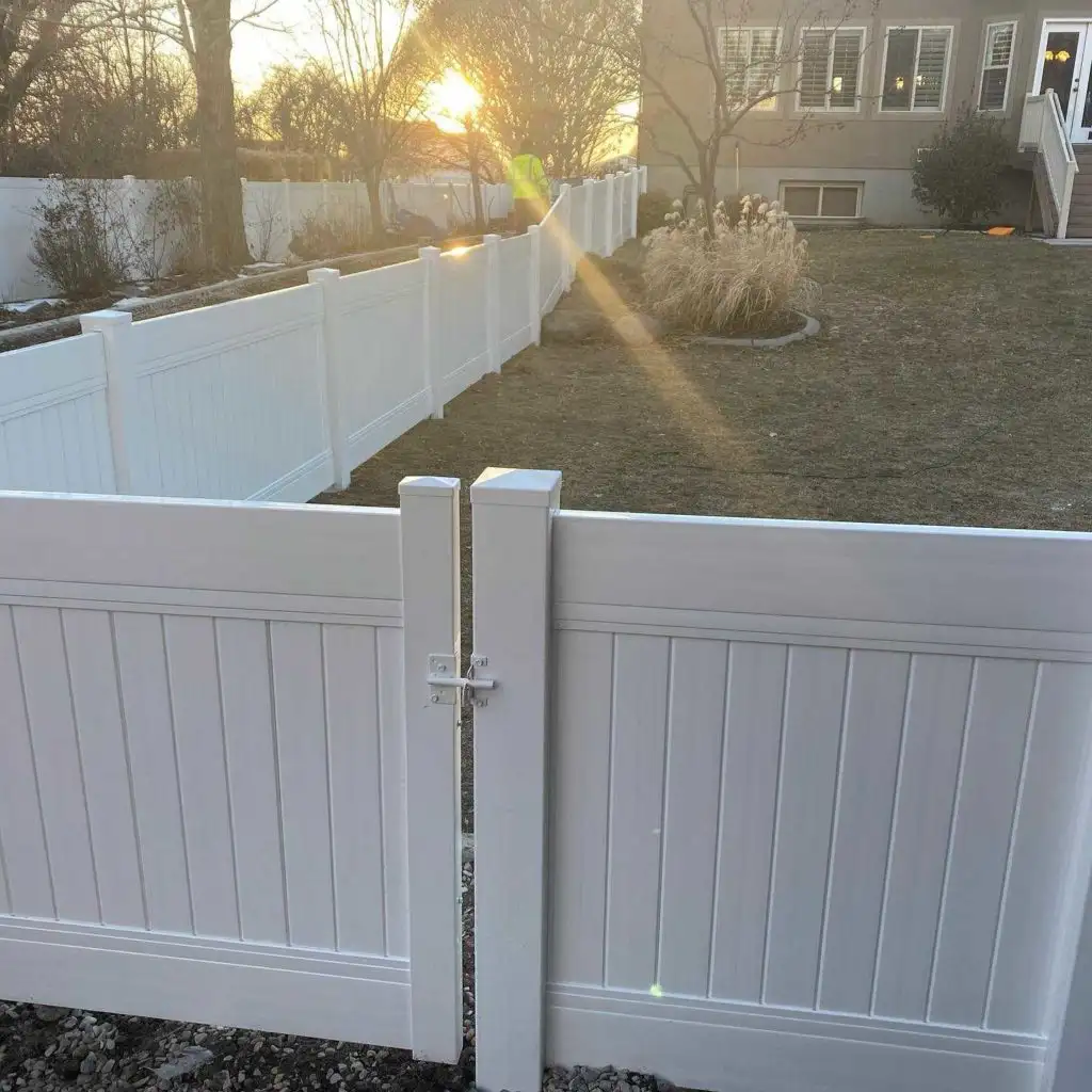 White vinyl privacy fence glowing at sunset in Lehi, Utah