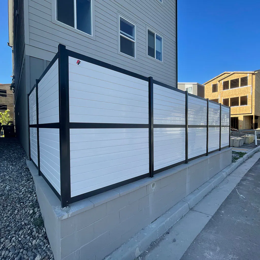 White horizontal vinyl fence with contrasting black posts in Utah County