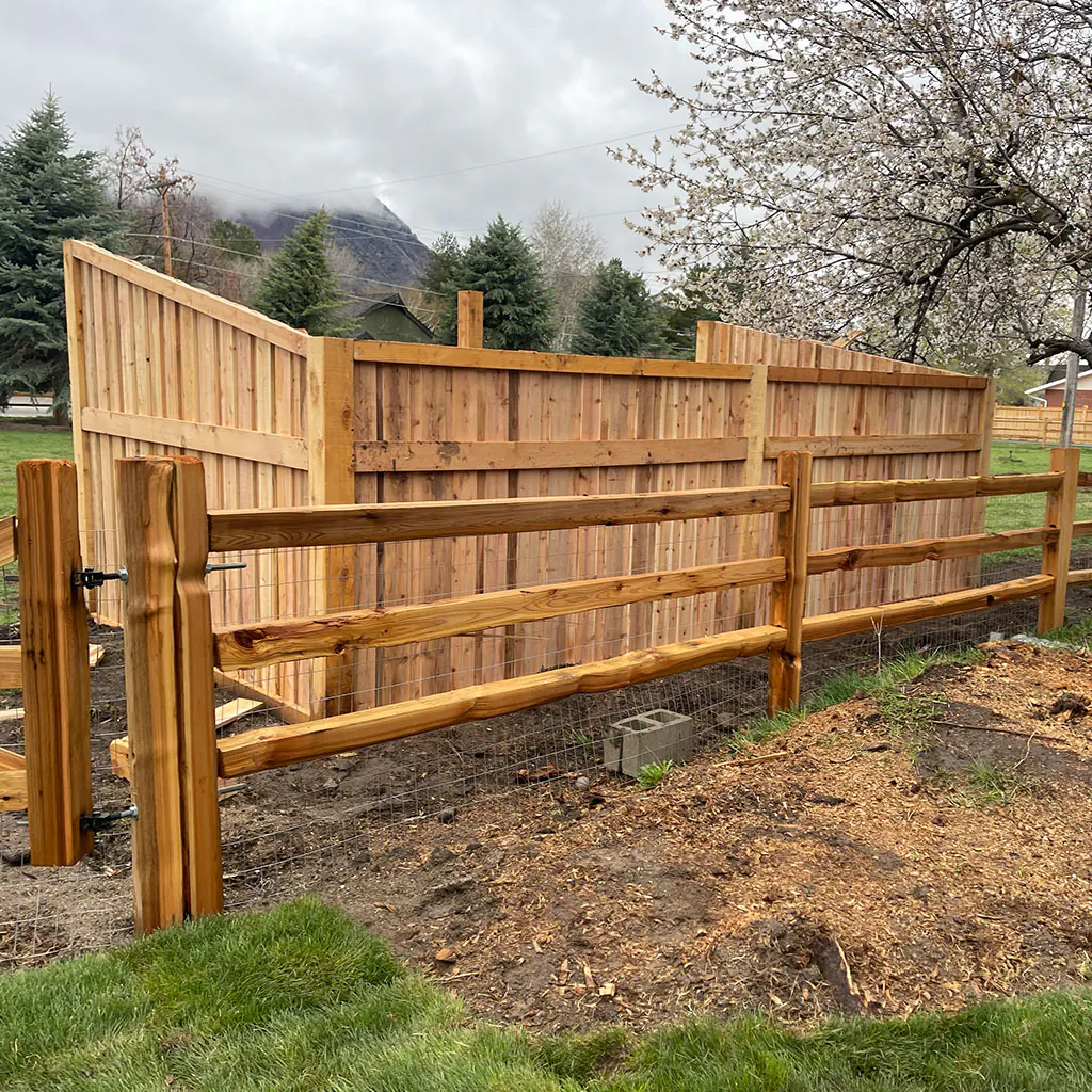 Cedar post-and-rail fence with a matching driveway gate in Utah County