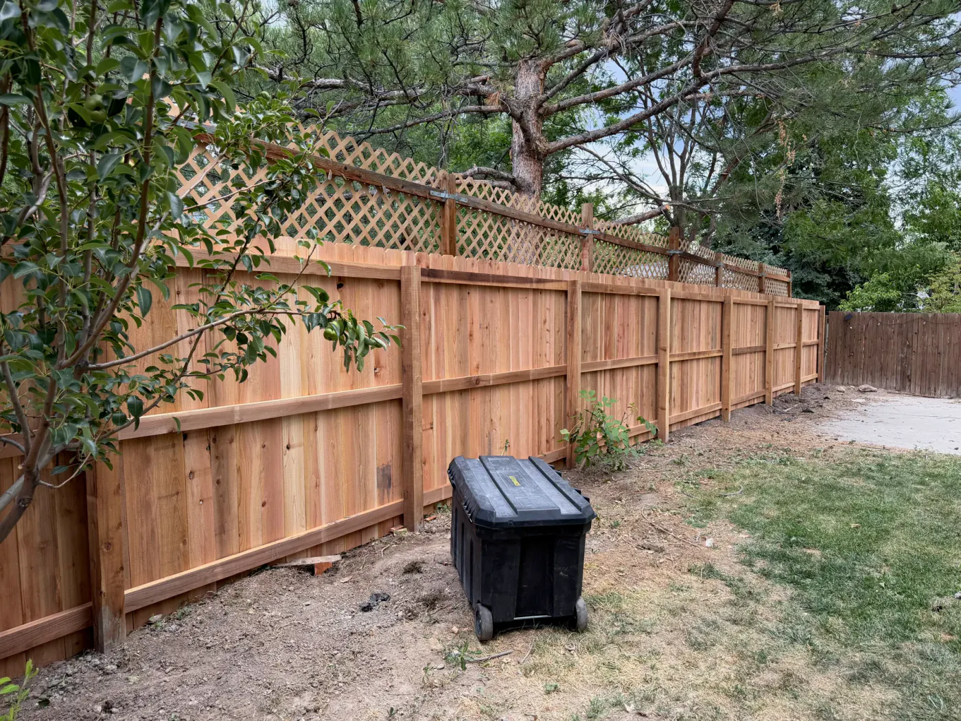 New cedar privacy fence with a lattice-top section installed at a Sandy, Utah home