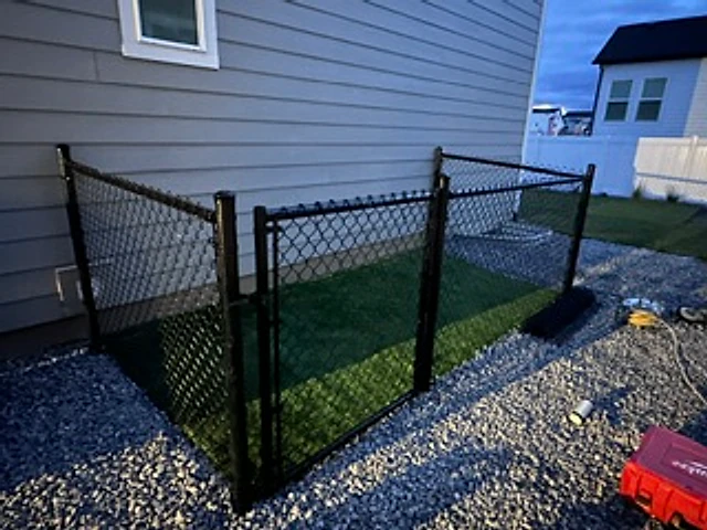 Black chain-link corner gate installed at a Utah property
