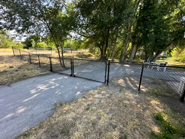 Black chain-link yard gate installed at a Utah property