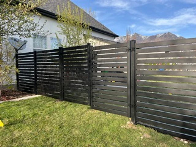 Black horizontal Avimore privacy fence with clean aluminum framing at a Utah property