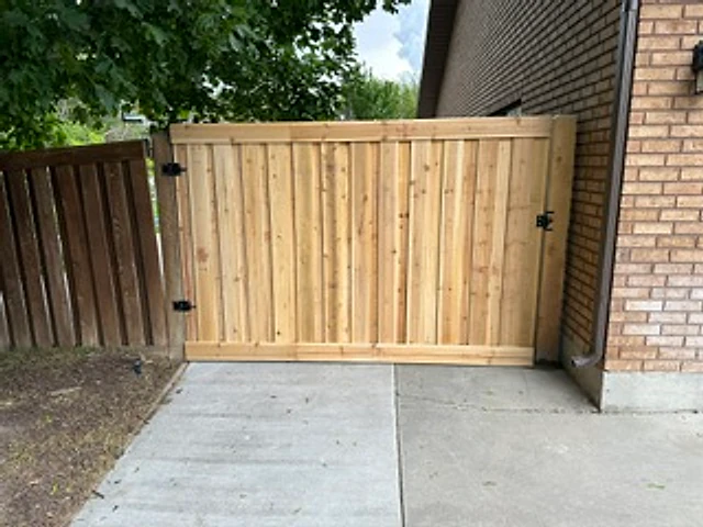 Cedar gate between masonry installed at a Utah property