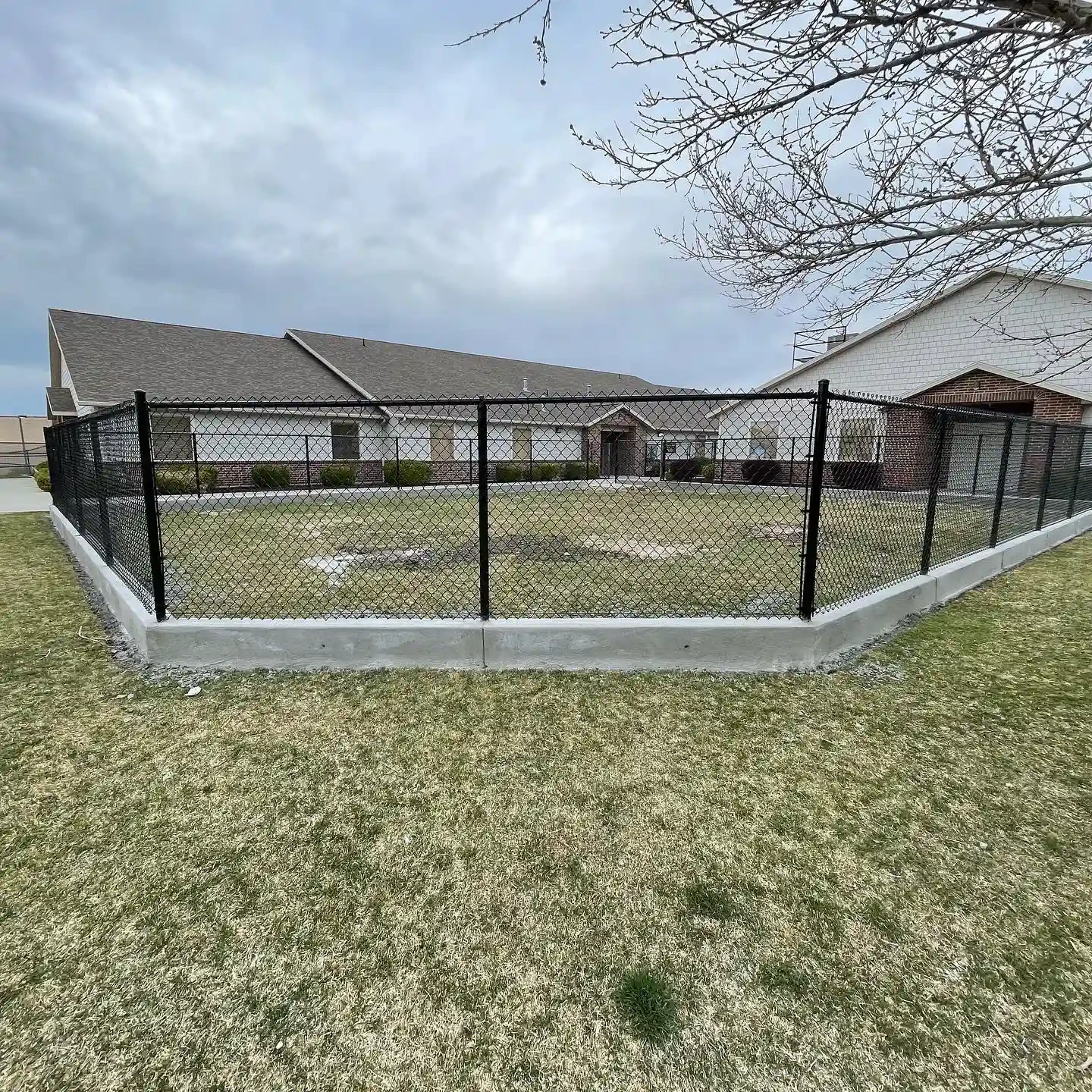 Concrete-base chain-link enclosure installed at a Utah property