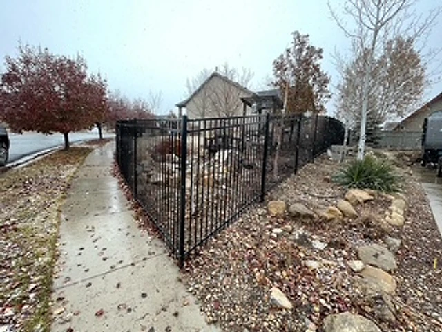 Curved garden iron fence installed at a Utah property
