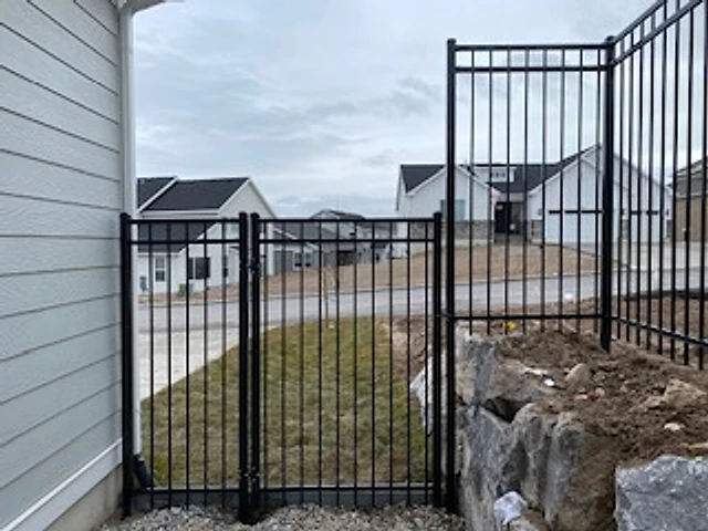 Narrow-yard iron gate installed at a Utah property