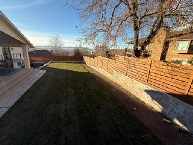 Sunlit horizontal cedar fence installed at a Utah property