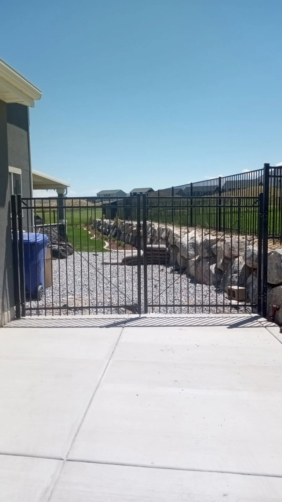 Tall iron pool gate installed at a Utah property