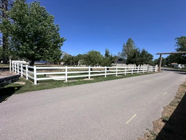 White ranch-rail approach installed at a Utah property