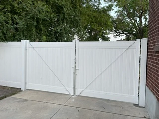 White vinyl driveway gate installed at a Utah property