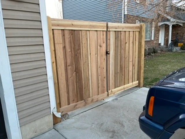 Wide cedar driveway gate installed at a Utah property